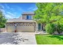 Charming two-story home with stone accents and a spacious three-car garage and manicured lawn at 1920 E 145Th Ave, Thornton, CO 80602