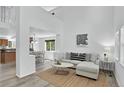 Bright living room featuring vaulted ceilings, modern decor, and light hardwood floors at 1920 E 145Th Ave, Thornton, CO 80602