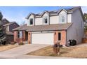 Charming two-story home featuring a two-car garage, solar panels, and a well-maintained front yard at 7292 Tenby Way, Castle Pines, CO 80108