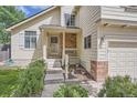 Welcoming front porch with brick accents and colorful potted flowers enhancing curb appeal at 9882 Harris St, Thornton, CO 80229
