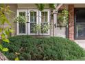 Close-up of an adorned front entrance with lush greenery and decorative accents at 9620 W Chatfield Ave # D, Littleton, CO 80128