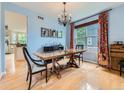 Elegant dining room featuring a wooden table, chandelier, and hardwood floors, perfect for gatherings and meals at 2896 Gemini Loop, Broomfield, CO 80023