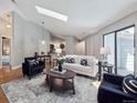 Bright living room features a skylight, contemporary furnishings, and open-concept layout at 5690 W 80Th Pl # 101, Arvada, CO 80003