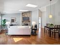 Open-concept living room featuring wood floors, stone fireplace, and skylights at 5690 W 80Th Pl # 101, Arvada, CO 80003
