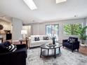 Living room with contemporary furnishings, and a sliding glass door to a balcony at 5690 W 80Th Pl # 101, Arvada, CO 80003