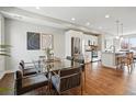 Open-concept kitchen and dining area with modern finishes and stainless steel appliances, perfect for entertaining at 1919 Eaton St, Lakewood, CO 80214