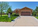 Charming single-story home with a well-manicured lawn, featuring a two-car garage and inviting curb appeal at 1294 Kittery St, Castle Rock, CO 80104