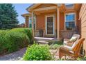 Welcoming front porch with seating, potted plants, and brick accents, adding charm to the home's entrance at 1294 Kittery St, Castle Rock, CO 80104