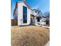 Beautiful two-story home with a white brick facade and lush, green front yard at 1620 S Ogden St, Denver, CO 80210