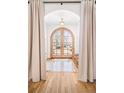 Elegant foyer with hardwood floors, arched doorway, and soft, neutral decor at 1620 S Ogden St, Denver, CO 80210