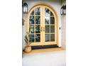 Inviting front door with an arched design, enhanced by stylish lighting fixtures and a welcome mat at 1620 S Ogden St, Denver, CO 80210