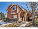 Attractive two-story home boasting a welcoming entrance, painted wood siding, and landscaped front yard at 19690 E Mann Creek Dr # A, Parker, CO 80134