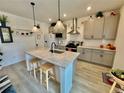 Bright kitchen features an island with granite counters, pendant lighting, and stainless appliances at 27580 E Cedar Pl, Aurora, CO 80018