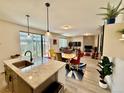 Open concept living and dining areas showcasing plenty of natural light and modern fixtures at 27580 E Cedar Pl, Aurora, CO 80018