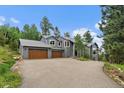 Charming two-story home with a three-car garage and well-maintained landscaping at 6637 Berry Bush Ln, Evergreen, CO 80439