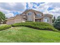 Landscaped front yard with green lawn and bushes framing a two-story home at 20886 Parliament Pl, Parker, CO 80138