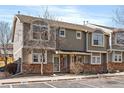 Inviting townhome exterior with stone accents, well-kept landscaping, and dedicated visitor parking spaces at 9150 Gale Blvd # 1, Thornton, CO 80260