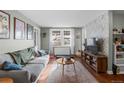 Bright living room with a comfortable gray sofa, stylish rug, and lots of natural light from the window at 2101 S Josephine St # 202, Denver, CO 80210