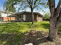 Inviting single-story brick home with manicured lawn, mature trees, and a convenient carport offering shade and protection at 3355 Moorhead Ave, Boulder, CO 80305