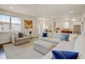 Cozy living room with large windows, comfortable seating, and seamless access to the adjacent kitchen area at 629 Jackson St, Lafayette, CO 80026
