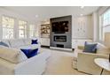Bright and airy living room featuring a modern fireplace, recessed lighting, and comfortable seating arrangement at 629 Jackson St, Lafayette, CO 80026