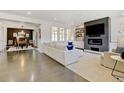 Spacious living room with a fireplace, large windows for plenty of light, and an adjacent dining area at 629 Jackson St, Lafayette, CO 80026