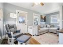 Comfortable living room with a gray sectional, plush rug, and a cozy rocking chair, perfect for relaxing at 130 N 8Th Ave, Brighton, CO 80601