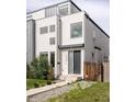 Contemporary-style two-story home with modern architectural details, neutral colors, and well-maintained lawn at 2685 S Acoma St, Denver, CO 80223