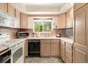 Efficient kitchen design with light wood cabinets, white appliances, and a window offering natural light at 4740 Lee Cir, Boulder, CO 80303