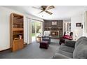 Cozy living room features a brick fireplace, comfortable seating, and a sliding door to the outdoor space at 4740 Lee Cir, Boulder, CO 80303