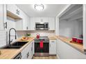 Updated kitchen featuring butcher block countertops, white subway tile, and stainless appliances at 9700 E Iliff Ave # A3, Denver, CO 80231