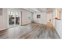 Bright living room with wood floors, white trim, and sliding door access to outdoor area at 9700 E Iliff Ave # A3, Denver, CO 80231
