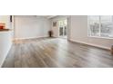 Well-lit living room boasts new flooring, white trim, and access to outdoor space at 9700 E Iliff Ave # A3, Denver, CO 80231