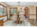 Bright dining room featuring pendant lighting, a glass top table, and views to the outdoors at 6723 Perry Park Blvd, Larkspur, CO 80118