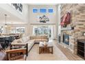 Inviting living room with large windows, stone fireplace, and comfortable sectional sofa at 52 Simmental Loop, Castle Rock, CO 80104