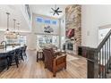 Bright living room featuring soaring ceilings and a floor-to-ceiling stone fireplace at 52 Simmental Loop, Castle Rock, CO 80104