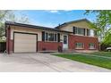 Charming brick home with solar panels, a well-maintained lawn, and attached garage at 821 Clarkson Ct, Denver, CO 80229
