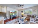 Cozy living room with hardwood floors, a ceiling fan, and a large window at 821 Clarkson Ct, Denver, CO 80229