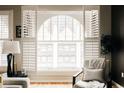 Cozy sitting area with modern furnishings and large arched window with shutter detail at 1555 California St # 609, Denver, CO 80202