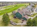 Aerial view of home featuring a large yard, mature trees, and a partial view of a golf course at 23427 Song Bird Hills Pl, Parker, CO 80138