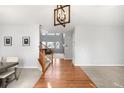 Inviting foyer with hardwood floors, staircase, and views into the living room showcasing natural light at 23427 Song Bird Hills Pl, Parker, CO 80138