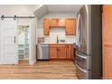 Well-organized kitchen featuring stainless steel appliances, light wood cabinets, and convenient access to pantry at 1071 Oak Cir, Lakewood, CO 80215