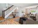 Open-concept living space with wood floors, seamlessly connecting the living and dining areas at 5721 S Jellison St, Littleton, CO 80123