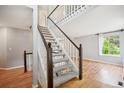 Bright foyer features a carpeted staircase with wooden railings, creating a welcoming entrance at 5721 S Jellison St, Littleton, CO 80123