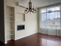 Bright living room featuring a fireplace, built-in shelving and an oversized window at 336 E 1St Ave # 310, Denver, CO 80203