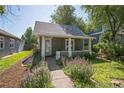 Charming home with a covered front porch and a beautifully landscaped yard at 3968 Winona Ct, Denver, CO 80212