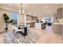 Bright, open concept kitchen with stainless steel appliances, a center island, and a seamless flow to the dining area at 2466 S Cherokee St, Denver, CO 80223