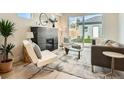 Bright living room boasts a modern fireplace, hardwood floors, and sliding glass doors to the backyard at 2466 S Cherokee St, Denver, CO 80223