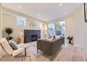 Bright living room with a fireplace, recessed lighting, and a sliding glass door to the backyard at 2466 S Cherokee St, Denver, CO 80223