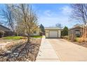 Lovely home showcasing a detached garage, well manicured lawn, and concrete driveway at 21 Snowmass Pl, Longmont, CO 80504